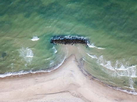 Liseleje, Denmark - April 4, 2020: Aerial drone view of a breakwater at Liseleje Beach.