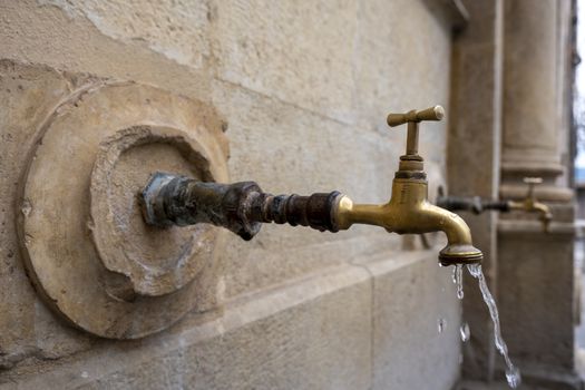 Urban fountain tap, detail of water for human consumption in Spello italy