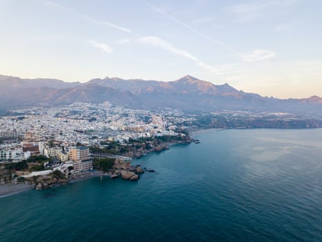 Nerja, Spain - May 28, 2019: Aerial drone view of Nerja and the Mediterranean Sea during sunset.