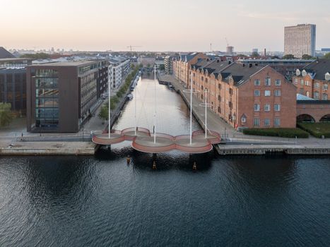 Copenhagen, Denmark - May 27, 2019: Aerial drone view of the modern Circle Bridge, a pedestrian bridge in the harbour area.