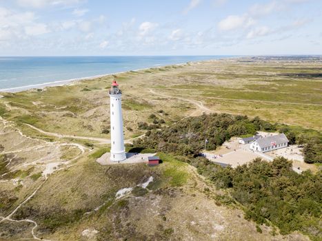 Hvide Sande, Denmark - July 10, 2019: Aerial drone view of Lyngvig Lighthouse at the Danish West Coast.