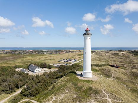 Hvide Sande, Denmark - July 10, 2019: Aerial drone view of Lyngvig Lighthouse at the Danish West Coast.