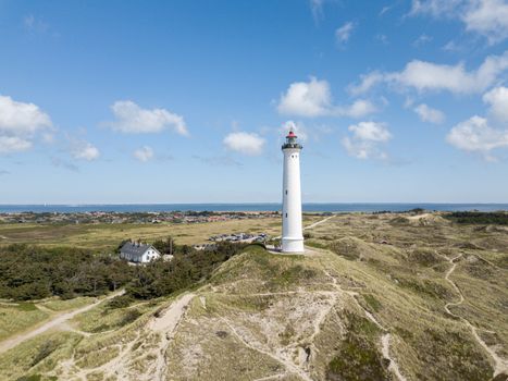 Hvide Sande, Denmark - July 10, 2019: Aerial drone view of Lyngvig Lighthouse at the Danish West Coast.