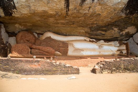 Sigiriya, Sri Lanka - August 17, 2018: A reclining buddha statue at Piduranagala Rock