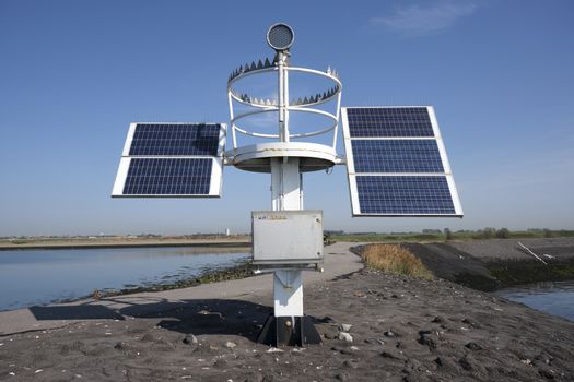 solar panel for lake harbor lighthouse energy, blue sky.
