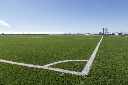 Qeqertarsuaq, Greenland - July 6, 2018: The soccer field with icebergs in the background