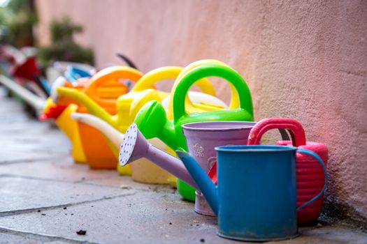 A Row of colorful watering cans for decoratiojn