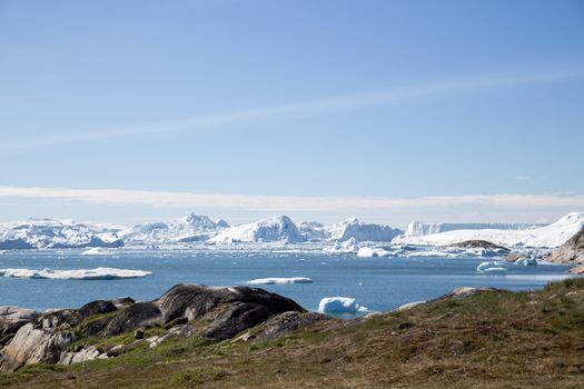 Ilulissat, Greenland - June 30, 2018: The Ilulissat Icefjord seen from the viewpoint. Ilulissat Icefjord was declared a UNESCO World Heritage Site in 2004.