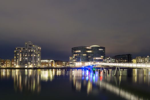 Copenhagen, Denmark - March 22, 2016: Modern cyclist and pedestrian bridge Bryggebroen and Gemini residence by night