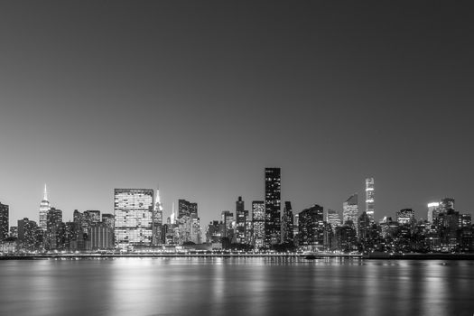 Black and white view of the skyline of midtown Manhattan in New York by night