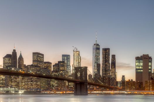 Skyline of Lower Manhattan and Brooklyn Bridge during sunset time