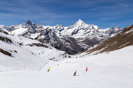 Zermatt, Switzerland - April 12, 2017: People skiing on ski pistes in the famous Matterhorn skiing area.