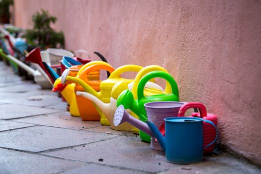 A Row of colorful watering cans for decoratiojn