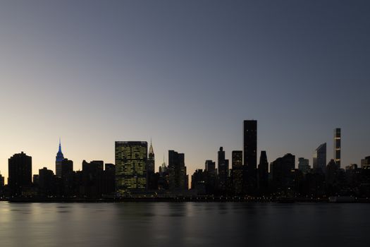Silhouette of the skyline of midtown Manhattan in New York during sunset time