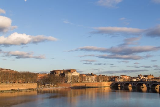View over Garonne River in Toulouse in France with the Daurade church.