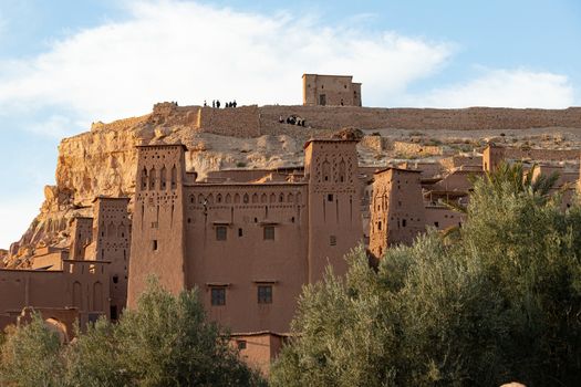 Ait Ben Haddou ksar Morocco, ancient fortress that is a Unesco Heritage site. Beautiful late afternoon light with honey, gold coloured mud brick construction the kasbah, or fortified town dates from 11th cent. and is on the former caravan route from the Sahara and Marrakech. The location has been used for many famous movies. High quality photo