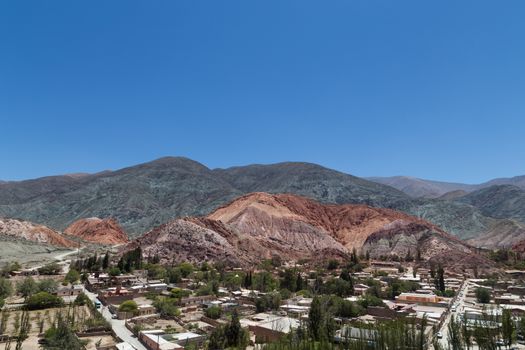 Photograph of the multicolored mountain called - cerro de los siete colores - in Purmamarca, Argentina.