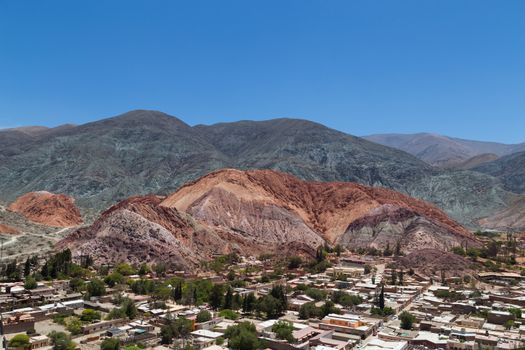 Photograph of the multicolored mountain called - cerro de los siete colores - in Purmamarca, Argentina.