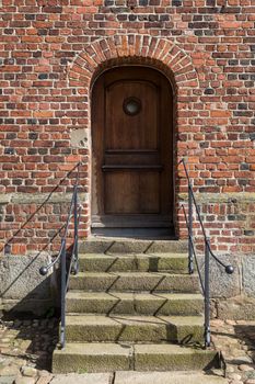 Photograph of a wooden door entrance door.