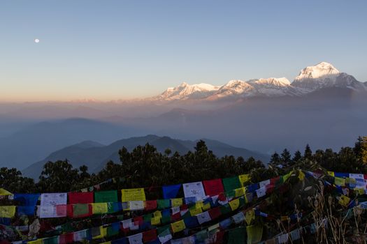Sunrise and full moon with view of Dhaulagiri mountain from Poon Hill on the Annapurna Circuit.