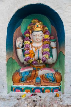 Kathmandu, Nepal - December 03, 2014: Small coloful buddhist statues at Boudhanath Stupa.