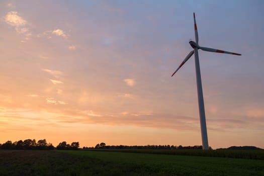 Lower Saxony, Germany - September 12, 2014: Silhouette of a wind power plant during sunset