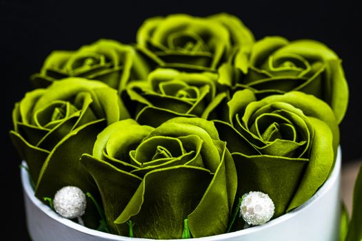 Green roses in a round luxury present box. Bouquet of flowers in a paper box isolated.