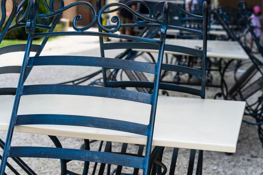 Close up of an empty table with empty chairs at a local outdoor resturant.