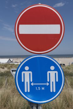 Road sign to remind people of social distancing. Keep 1.5 meter distance, together against COVID-19