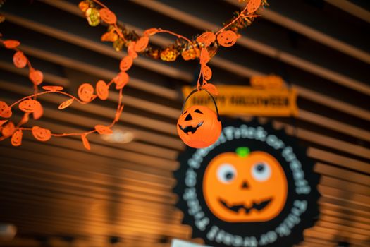 Festive Halloween cartoon decoration hanging on the ceiling of room interior, close up.