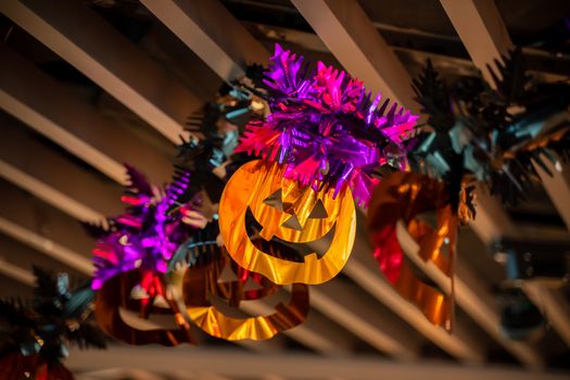 Festive Halloween cartoon decoration hanging on the ceiling of room interior, close up.