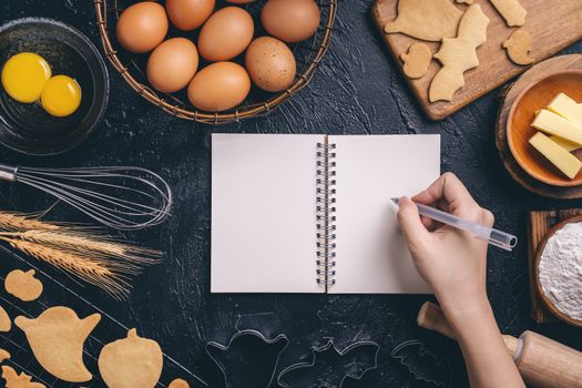 Design concept of making Halloween cookies, baking recipe ingredients layout of preparing party, top view, flat lay, overhead, blank copy space.