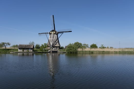 Netherlands rural lanscape with windmills at famous tourist site Kinderdijk in Holland. Unesco site.