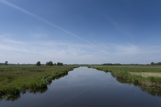 Dutch polder landscape early in the morning on a sunny day in the spring season