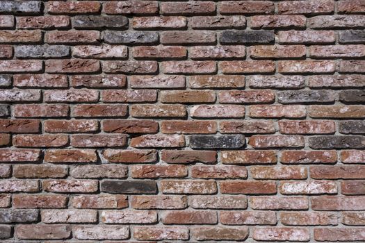 Weathered texture of stained old dark brown and red brick wall background, grungy rusty blocks of stone-work technology, colorful horizontal architecture