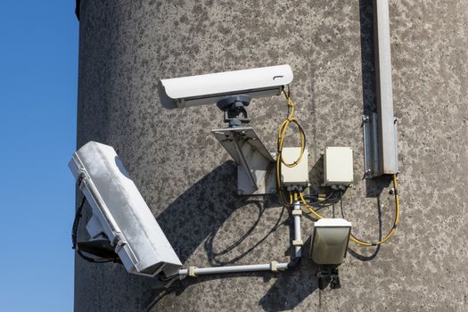 Security camera's outside with blue sky backdrop