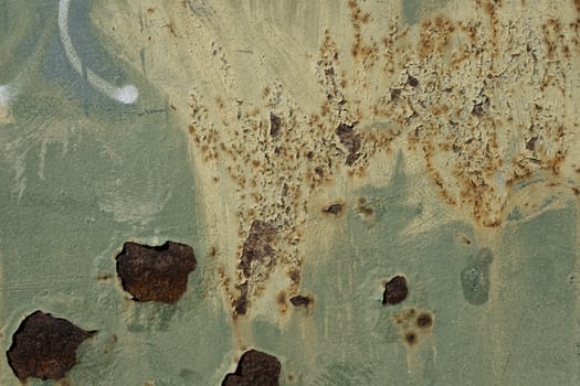 Rusty metal surface with colored paint flaking and cracking texture