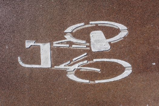 A high angle closeup shot of a bicycle sign painted on a cycle path