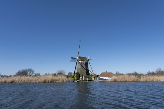 Dutch windmil an UNESCO world heritage site. Stone brick Windmill with water.
