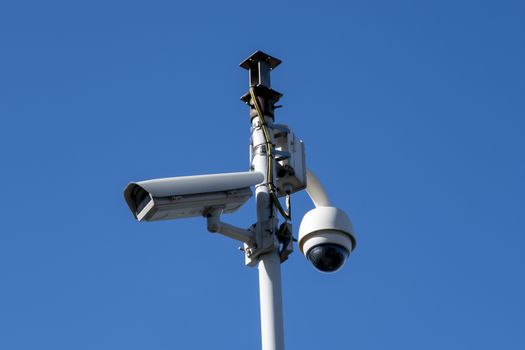 Security camera's outside with blue sky backdrop