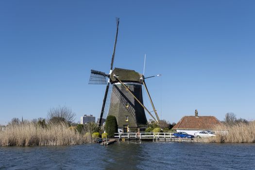 Dutch windmil an UNESCO world heritage site. Stone brick Windmill with water.