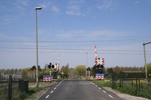 Road signs at the railway crossing with a barrier. Organization of the transport system of a European country. Safety of traffic in road and rail transport, Rotterdam Netherlands