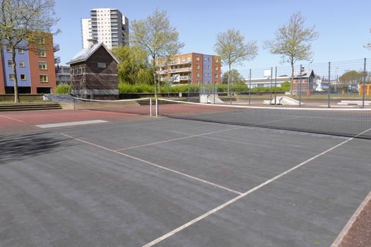 Public tennis courts with green and red marking with no players