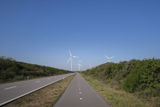 A Modern Wind Farm consisting of Wind Turbines with Two and Three Blades along the Shore of the Netherlands