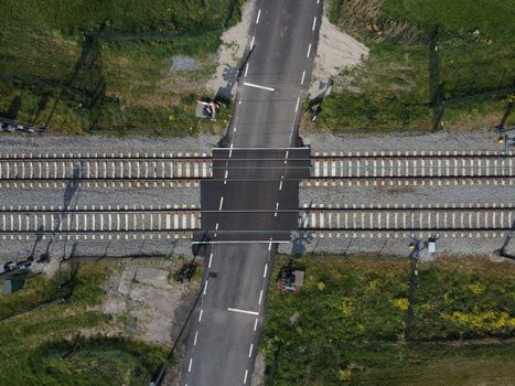 Railroad crossing and Train Tracks from Above. Aerial view