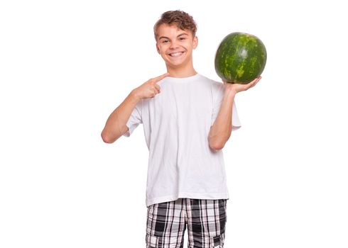 Portrait of teen boy eating ripe juicy watermelon and smiling.