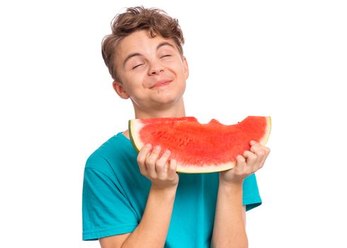 Portrait of teen boy eating ripe juicy watermelon and smiling.