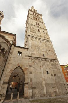 Ghirlandina ancient tower and duomo from below in Modena city, Italy