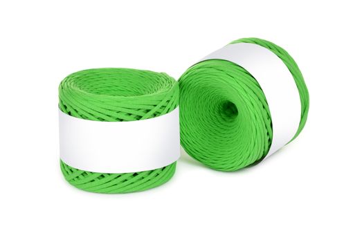 Two skeins of green color elastic knitted cotton yarn for crochet. Roll with mockup label layout on white background. Use for handwork, creating wicker baskets and home accessories.