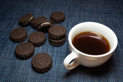 White cup of coffee and brown biscuits